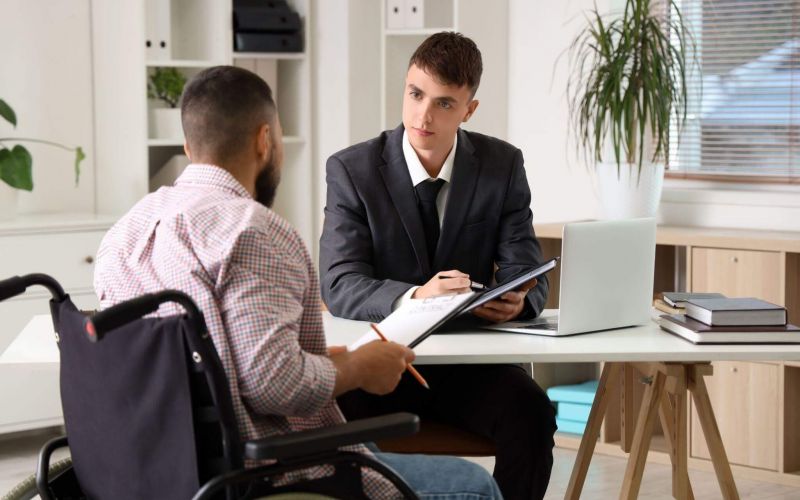 Lawyer consulting man in wheelchair