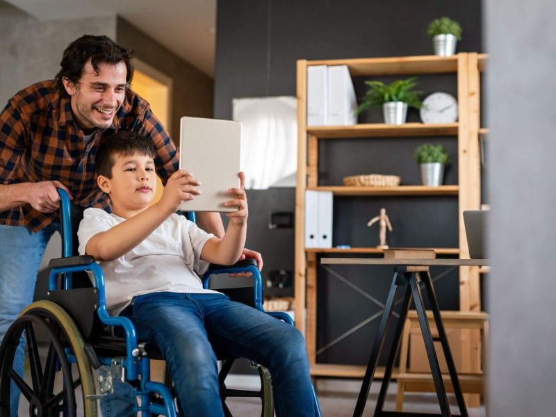 a man and a boy in a wheelchair