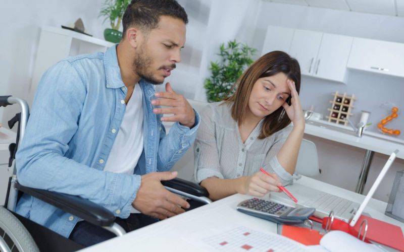 Two people in wheelchairs discussing social security benefits