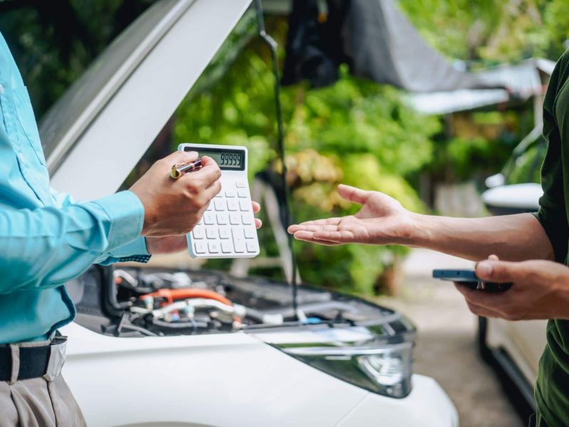 a couple of people standing next to a car