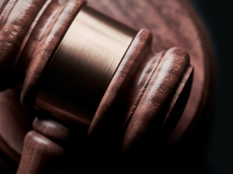 Close-up of a wooden judge's gavel on a sound block, symbolizing justice and legal authority.