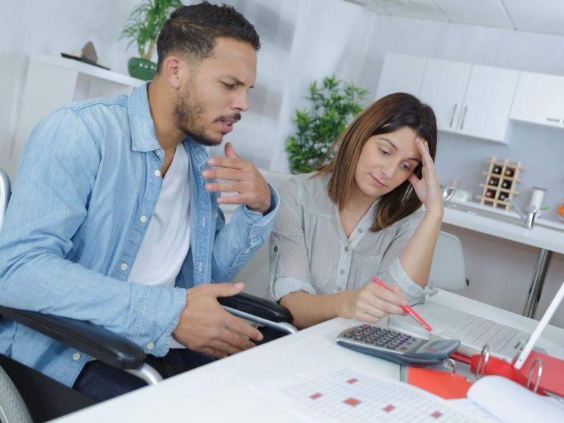 Two people in wheelchairs discussing social security benefits