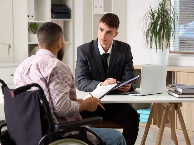 Lawyer consulting man in wheelchair