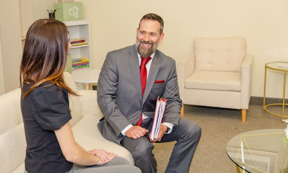 A happy client shakes hands with a personal injury lawyer after a successful settlement
