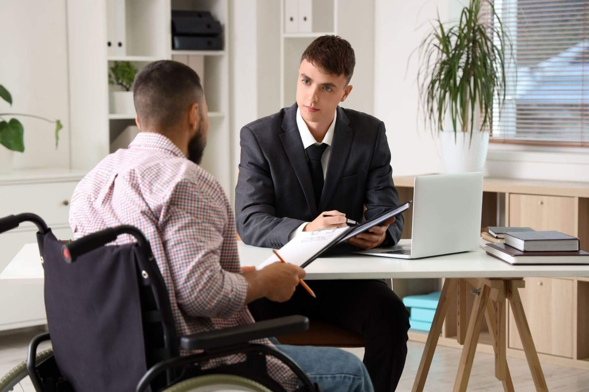 Lawyer consulting man in wheelchair