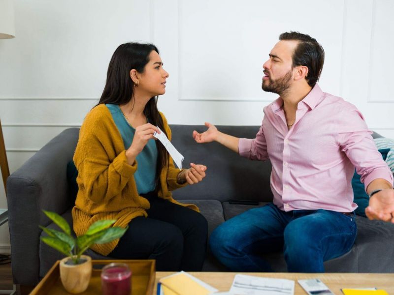 A man and a woman discussing debt responsibilities after separation