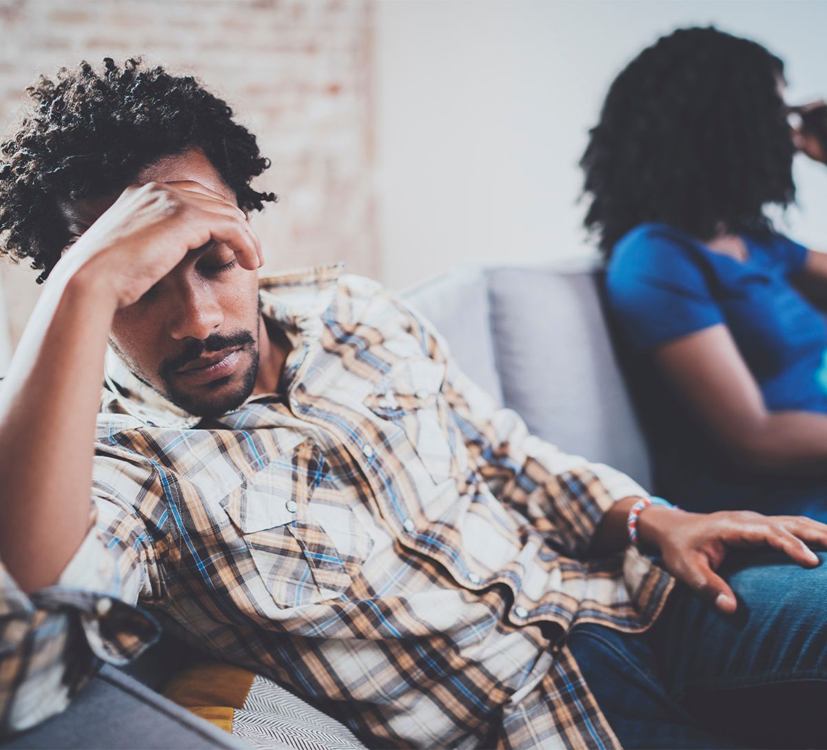 couple fighting on couch who need a divorce