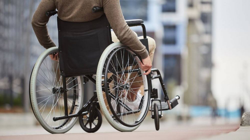 A man in wheelchair negotiating city streets