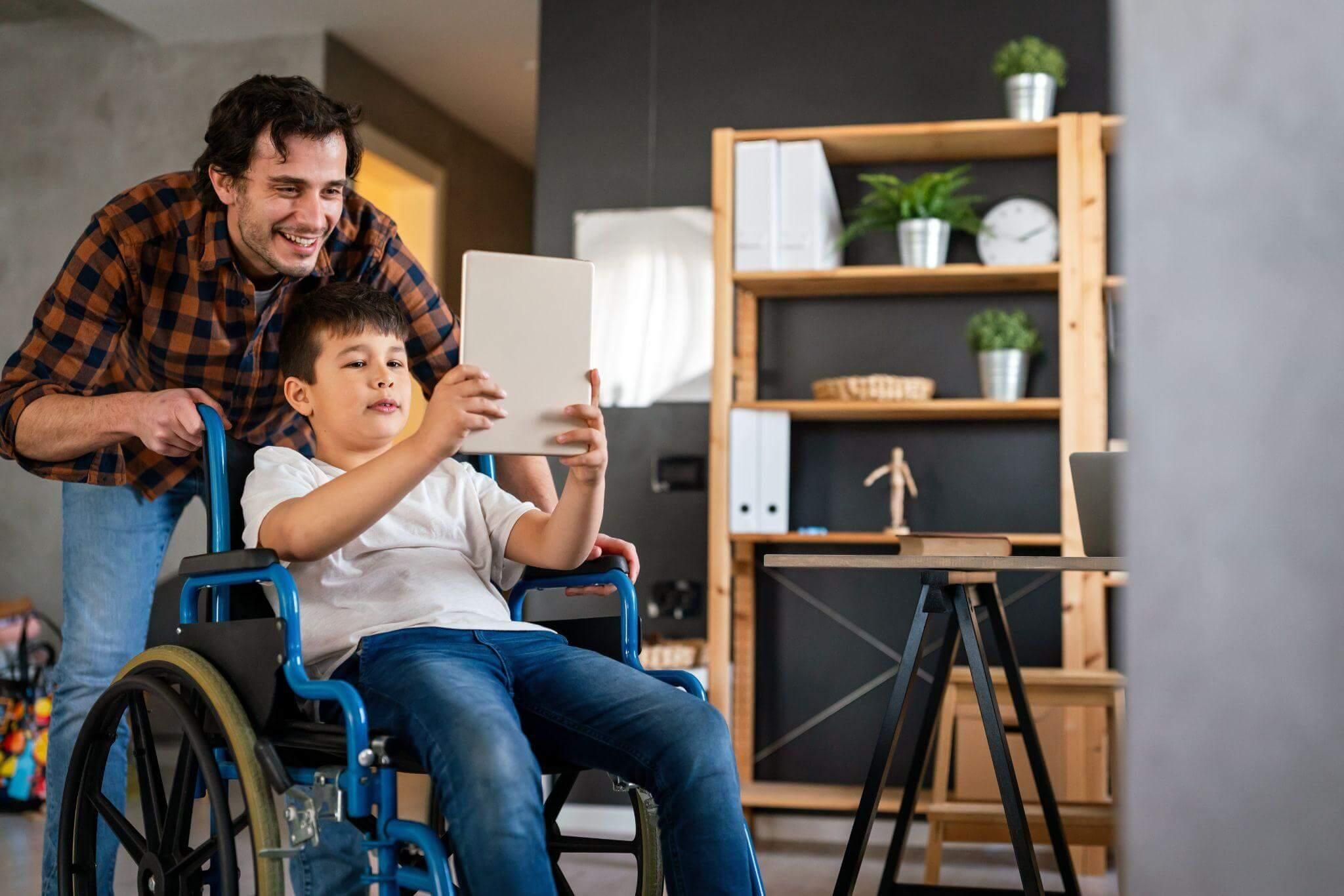 a man and a boy in a wheelchair