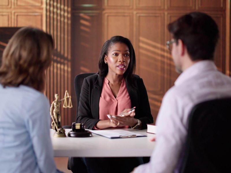 Three women discussing divorce costs at a table