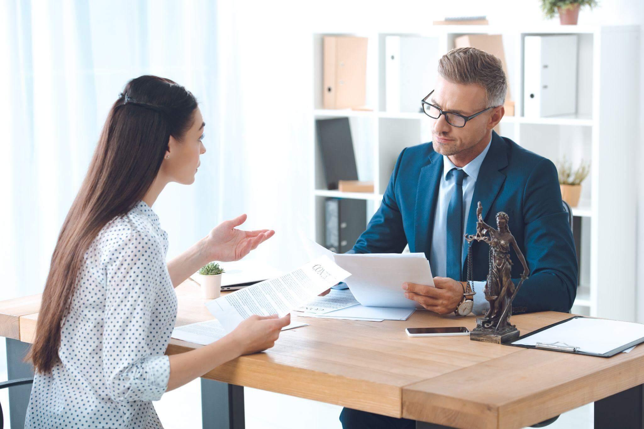 Man and woman discussing disability benefits at table