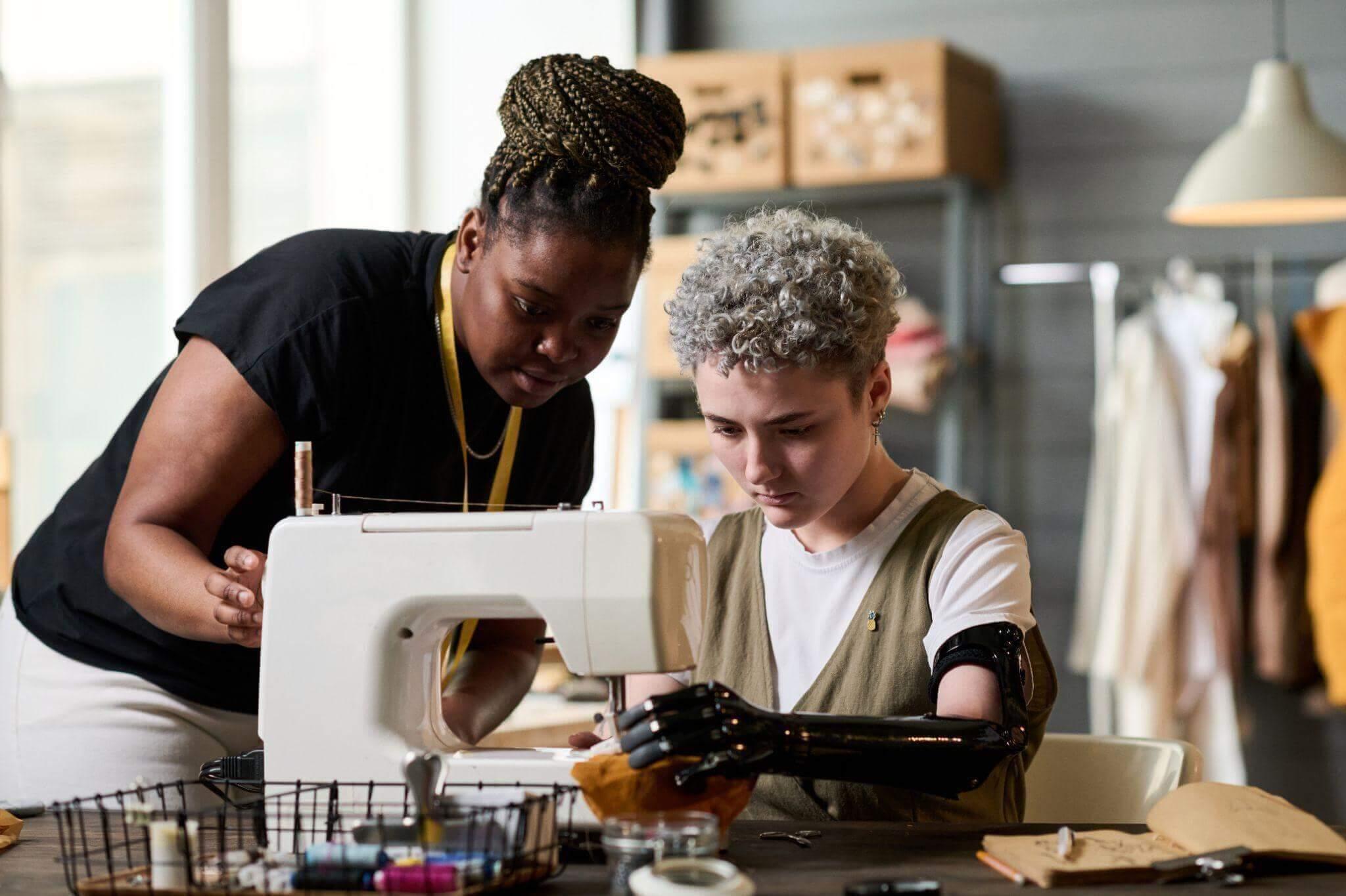 Woman sewing at machine inside work environment