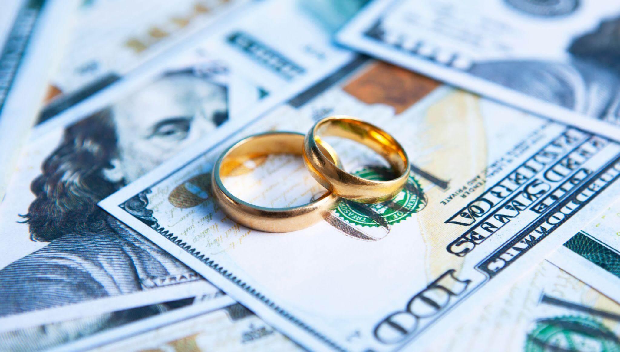 Wedding rings on money illustrating divorce costs