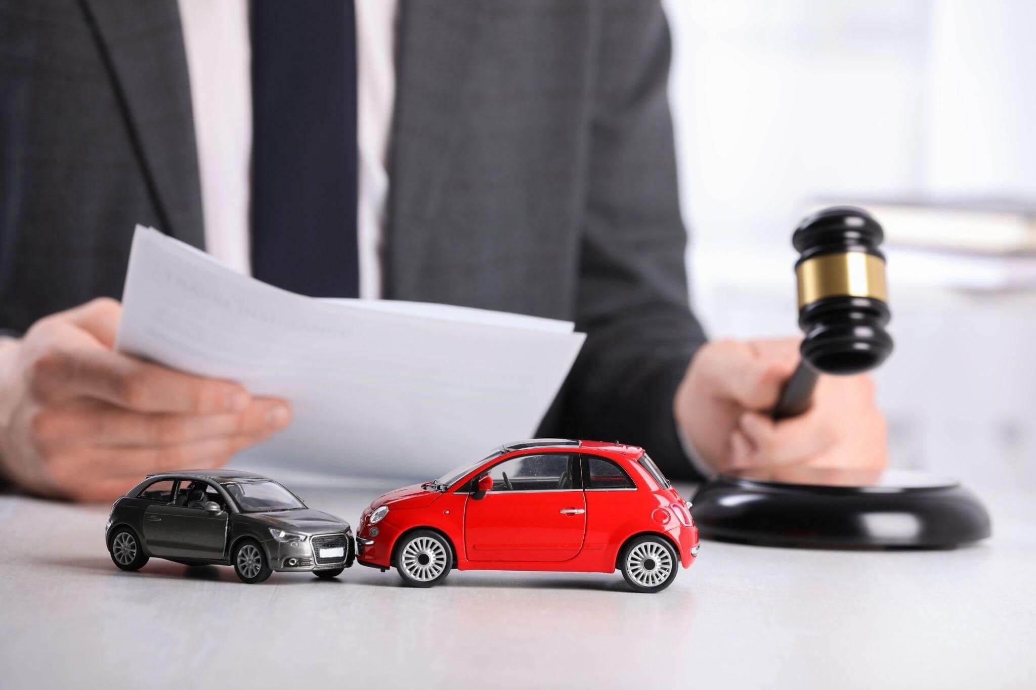 a miniature car and a toy car on a table