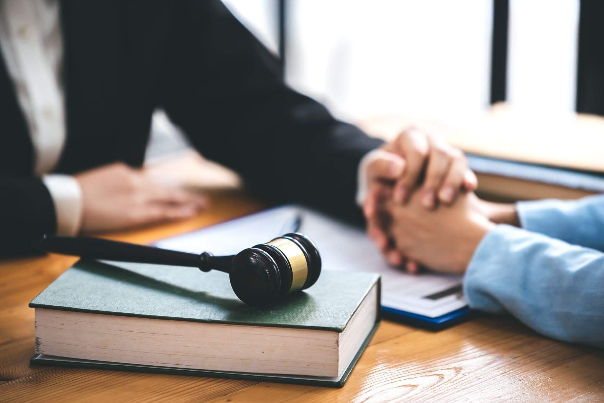 two people sitting at a table with a judge