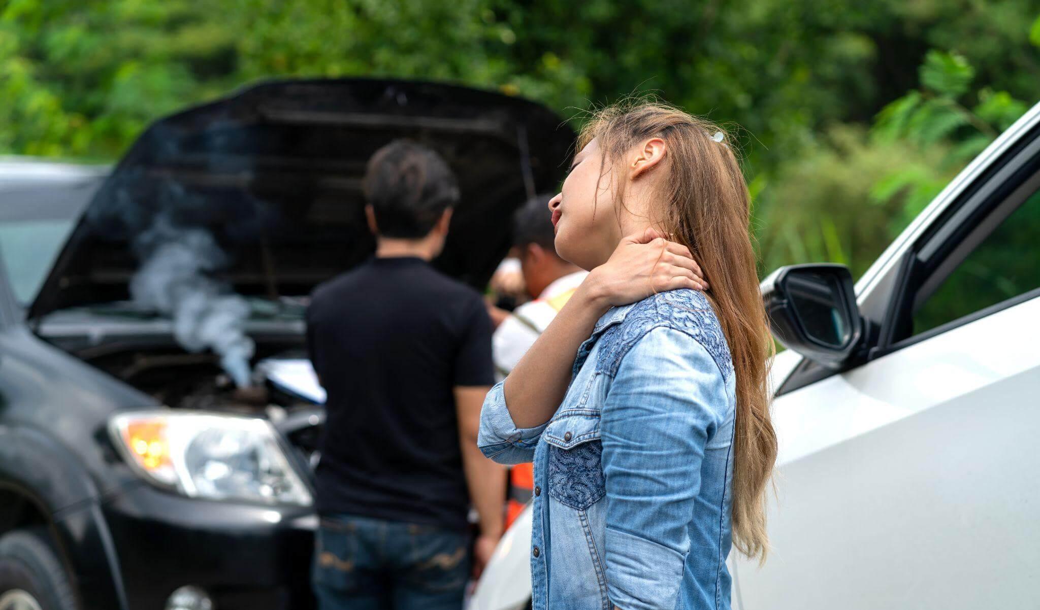 a woman standing next to a car with the hood open