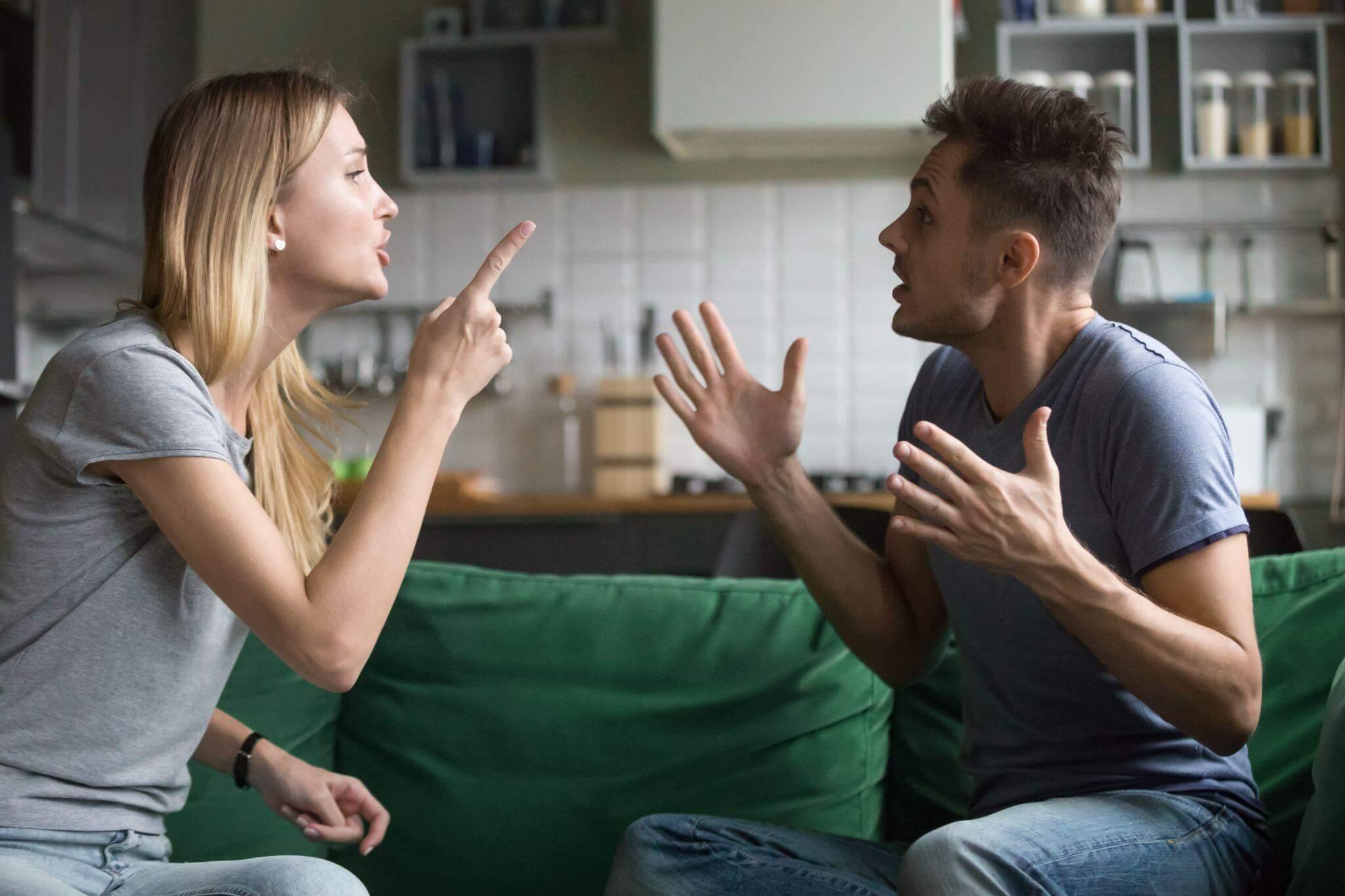a man and a woman sitting on a green couch