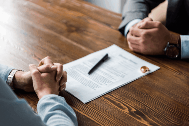 two people shaking hands in front of a judge
