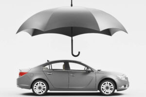 a red motorcycle parked next to a black car