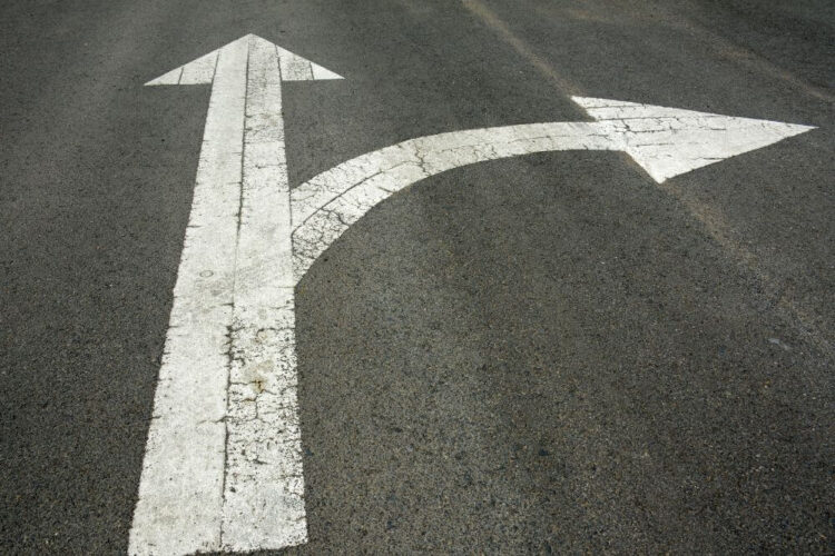 two people shaking hands over a signed document