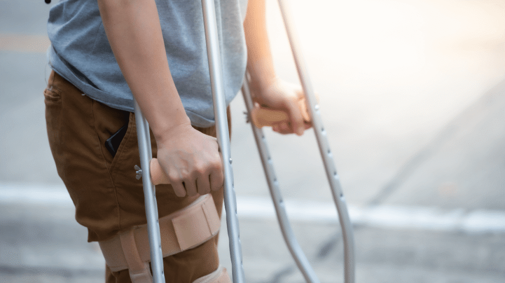 Injured man using crutches