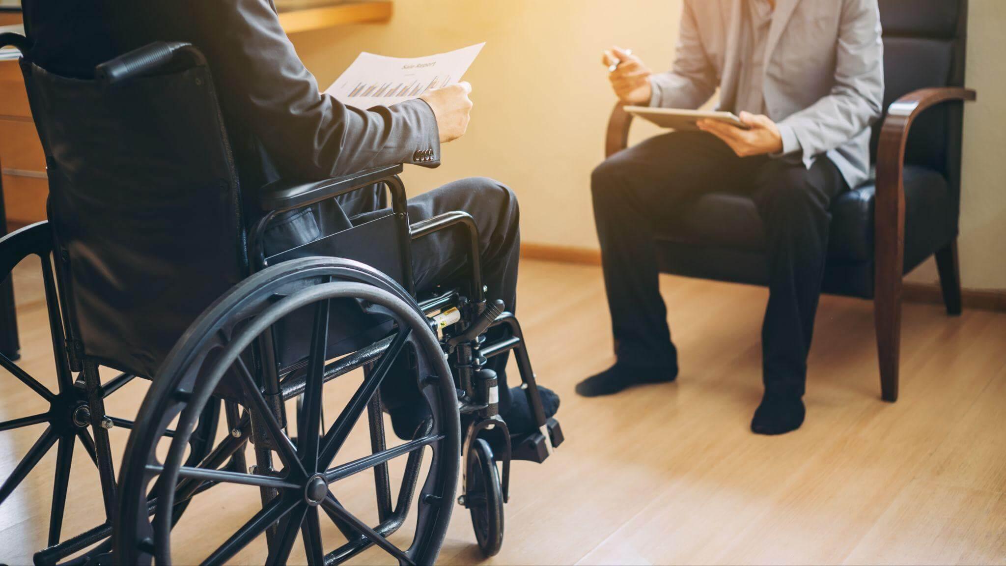 Man in a suit in a wheelchair appealing social security benefits denial