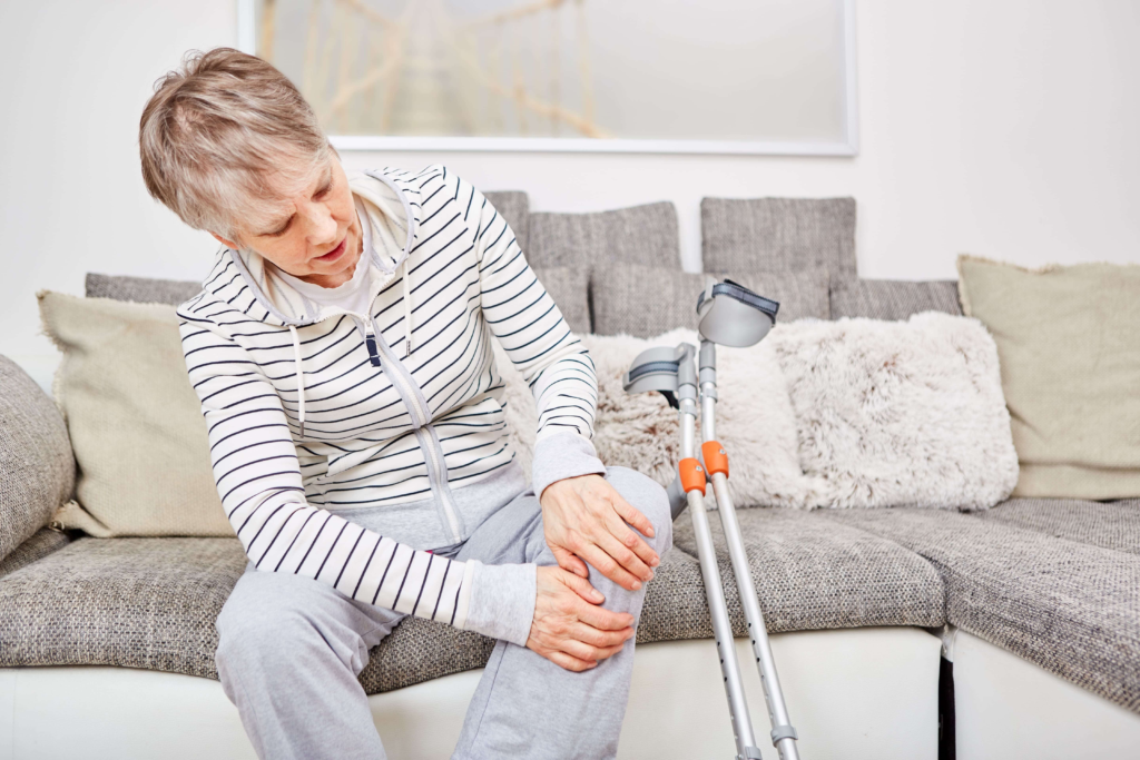 Person in a wheelchair using a tablet during a business meeting with a colleague at a desk.