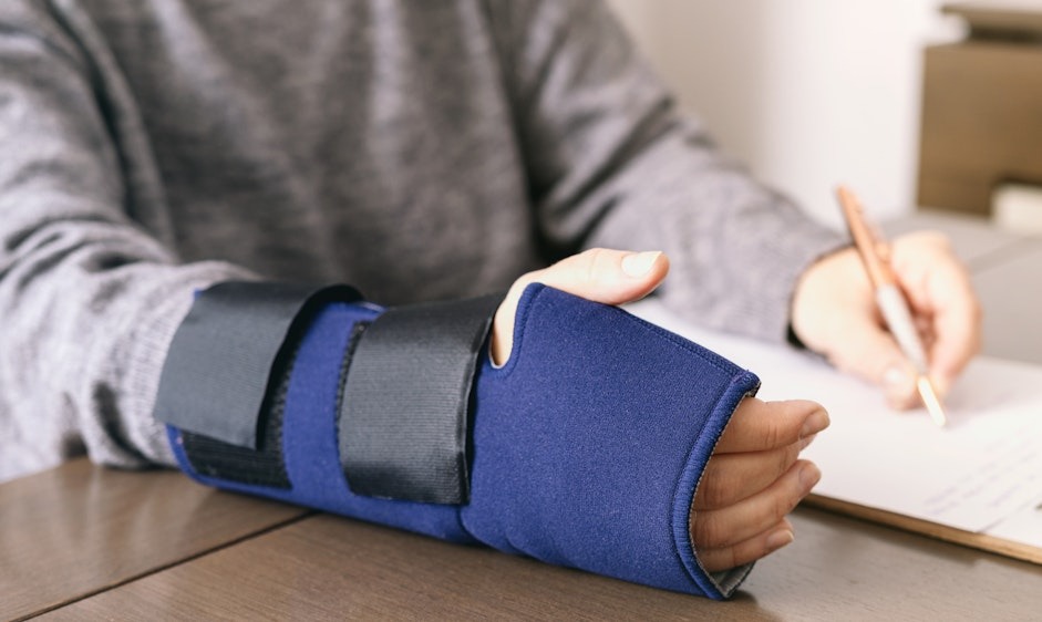 Young worker with an injured wrist completing the settlement.